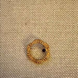 Elegant Gold Brooch with Black Accent